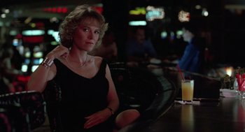 Movie still from “Rain Man” (1988), directed by Barry Levinson – A woman sitting at a table in front of drinks; Medium shot, Low angle