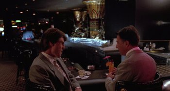 Movie still from “Rain Man” (1988), directed by Barry Levinson – Two men are sitting at a table in a bar; Medium shot, Over the shoulder angle