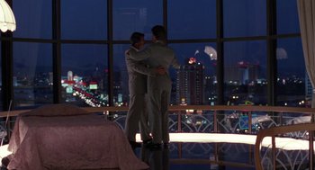 Movie still from “Rain Man” (1988), directed by Barry Levinson – A couple of men standing next to each other in front of a window; Wide shot, Overhead angle