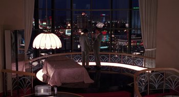 Movie still from “Rain Man” (1988), directed by Barry Levinson – Two men standing in front of a window in a hotel room; Wide shot, High angle
