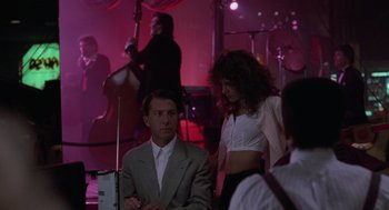 Movie still from “Rain Man” (1988), directed by Barry Levinson – A man and a woman are in front of a band; Medium shot, Over the shoulder angle