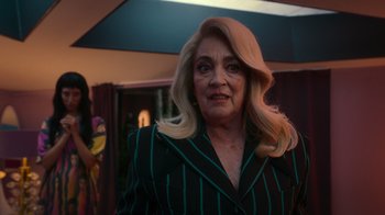 Movie still from “Rainbow” (2022), directed by Paco León – A person wearing a suit; Medium shot, Over the shoulder angle