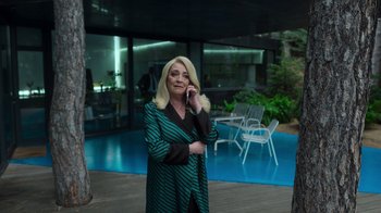 Movie still from “Rainbow” (2022), directed by Paco León – A woman standing outside talking on a cell phone; Medium shot, Low angle