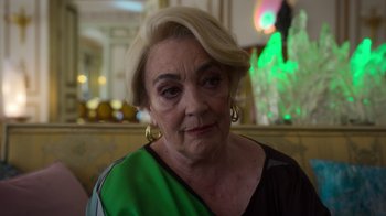 Movie still from “Rainbow” (2022), directed by Paco León – An older woman with blonde hair wearing a green shirt; Close Up shot, Over the shoulder angle