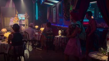 Movie still from “Rainbow” (2022), directed by Paco León – People are sitting at tables in a restaurant; Wide shot, Over the shoulder angle