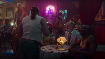 Movie still from “Rainbow” (2022), directed by Paco León – A man sitting at a table in front of a woman; Wide shot, Over the shoulder angle