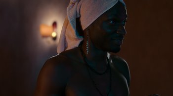 Movie still from “Rainbow” (2022), directed by Paco León – A man with a towel on his head; Close Up shot, Low angle