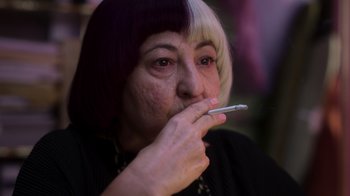 Movie still from “Rainbow” (2022), directed by Paco León – A woman with purple and white hair smoking a cigarette; Close Up shot, High angle