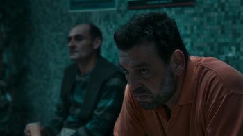 Movie still from “Rainbow” (2022), directed by Paco León – Two men sitting next to each other in a room; Close Up shot, Low angle