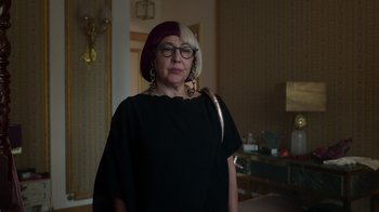 Movie still from “Rainbow” (2022), directed by Paco León – A woman in a black shirt and a red hat; Close Up shot, Over the shoulder angle