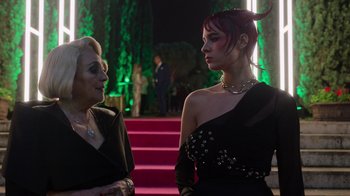 Movie still from “Rainbow” (2022), directed by Paco León – A woman in a black dress talking to another woman in a black dress; Medium shot, Over the shoulder angle