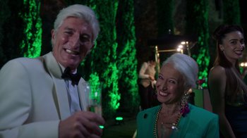 Movie still from “Rainbow” (2022), directed by Paco León – A man and a woman are smiling for the camera; Medium shot, Over the shoulder angle