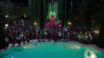 Movie still from “Rainbow” (2022), directed by Paco León – A group of people standing around a pool at night; Extreme Wide shot, High angle