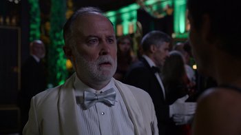 Movie still from “Rainbow” (2022), directed by Paco León – An older man wearing a white tuxedo and a bow tie; Close Up shot, Over the shoulder angle