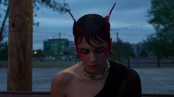 Movie still from “Rainbow” (2022), directed by Paco León – A woman with a red head band on her head; Close Up shot, High angle