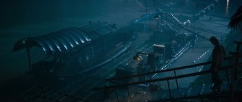 Movie still from “Rambo” (2008), directed by Sylvester Stallone – A view of a train station in the rain from above; Extreme Wide shot, High angle