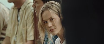 Movie still from “Rambo” (2008), directed by Sylvester Stallone – A person with long blonde hair; Close Up shot, Over the shoulder angle