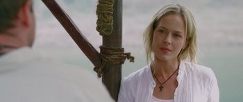 Movie still from “Rambo” (2008), directed by Sylvester Stallone – A woman standing next to a pole with ropes hanging from it; Close Up shot, Over the shoulder angle