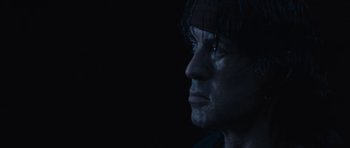 Movie still from “Rambo” (2008), directed by Sylvester Stallone – A person's face in the dark; Close Up shot, Low angle