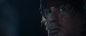 Movie still from “Rambo” (2008), directed by Sylvester Stallone – A person wearing a hat and looking into the distance; Extreme Close Up shot, Low angle