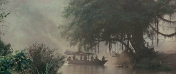 Movie still from “Rambo” (2008), directed by Sylvester Stallone – A group of people in a boat on a body of water; Extreme Wide shot, High angle