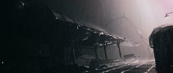 Movie still from “Rambo” (2008), directed by Sylvester Stallone – A train station in the middle of the rain; Extreme Wide shot, Low angle