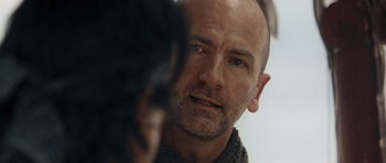 Movie still from “Rambo” (2008), directed by Sylvester Stallone – A person looking at a camera; Close Up shot, Over the shoulder angle