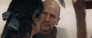 Movie still from “Rambo” (2008), directed by Sylvester Stallone – A man with a beard looking into a mirror; Close Up shot, Over the shoulder angle