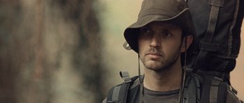 Movie still from “Rambo” (2008), directed by Sylvester Stallone – A person wearing a hat; Close Up shot, Low angle