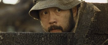 Movie still from “Rambo” (2008), directed by Sylvester Stallone – A person wearing a hat; Close Up shot, High angle