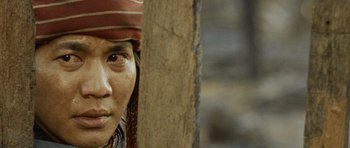 Movie still from “Rambo” (2008), directed by Sylvester Stallone – A person wearing a hat; Close Up shot, Over the shoulder angle