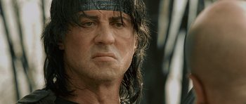 Movie still from “Rambo” (2008), directed by Sylvester Stallone – A person with long black hair; Close Up shot, Low angle