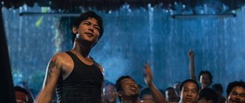 Movie still from “Rambo” (2008), directed by Sylvester Stallone – A group of men standing next to each other in front of a waterfall; Medium shot, Low angle