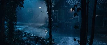 Movie still from “Rambo” (2008), directed by Sylvester Stallone – A tree in the middle of a street in the rain at night; Wide shot, High angle