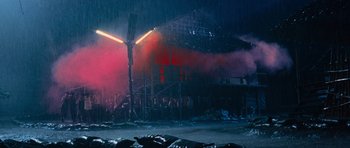 Movie still from “Rambo” (2008), directed by Sylvester Stallone – A large group of people standing in the rain; Extreme Wide shot, Low angle