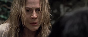 Movie still from “Rambo” (2008), directed by Sylvester Stallone – A person with long blonde hair; Close Up shot, Over the shoulder angle