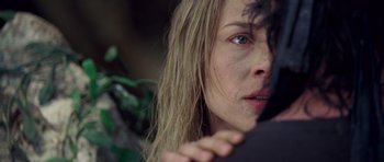 Movie still from “Rambo” (2008), directed by Sylvester Stallone – A woman's face with her hand on her face; Close Up shot, Over the shoulder angle