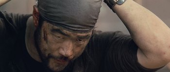 Movie still from “Rambo” (2008), directed by Sylvester Stallone – A person wearing a hat; Close Up shot, Low angle