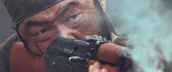 Movie still from “Rambo” (2008), directed by Sylvester Stallone – A person holding a gun; Extreme Close Up shot, Low angle
