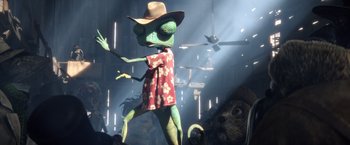 Movie still from “Rango” (2011), directed by Gore Verbinski – A green lizard wearing a cowboy hat standing next to a bunch of animals; Wide shot, Low angle