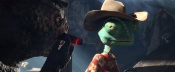 Movie still from “Rango” (2011), directed by Gore Verbinski – A green creature with a hat and a red pipe in his mouth; Close Up shot, Over the shoulder angle