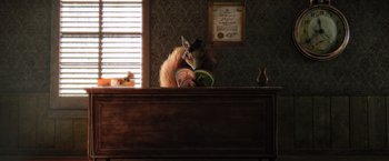 Movie still from “Rango” (2011), directed by Gore Verbinski – A squirrel sitting on top of a wooden desk; Wide shot, High angle