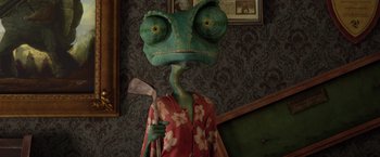 Movie still from “Rango” (2011), directed by Gore Verbinski – A person with a lizard head holding an axe; Medium shot, Over the shoulder angle