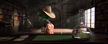 Movie still from “Rango” (2011), directed by Gore Verbinski – An alien wearing a cowboy hat is standing in a room; Medium shot, High angle