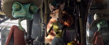 Movie still from “Rango” (2011), directed by Gore Verbinski – A woman dressed as a fox holding a paintbrush in her mouth; Medium shot, Over the shoulder angle