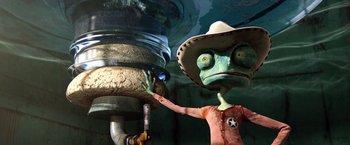 Movie still from “Rango” (2011), directed by Gore Verbinski – A green and brown robot wearing a cowboy hat; Medium shot, Overhead angle