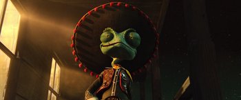 Movie still from “Rango” (2011), directed by Gore Verbinski – A green lizard wearing a sombrero and a red hat; Close Up shot, Low angle