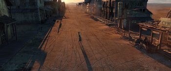 Movie still from “Rango” (2011), directed by Gore Verbinski – A person walking down a dirt road in the middle of the day; Extreme Wide shot, High angle