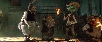 Movie still from “Rango” (2011), directed by Gore Verbinski – A group of people standing next to each other holding a torch; Wide shot, Low angle