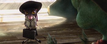 Movie still from “Rango” (2011), directed by Gore Verbinski – An animal with a black hat is sitting on a wooden floor; Wide shot, High angle